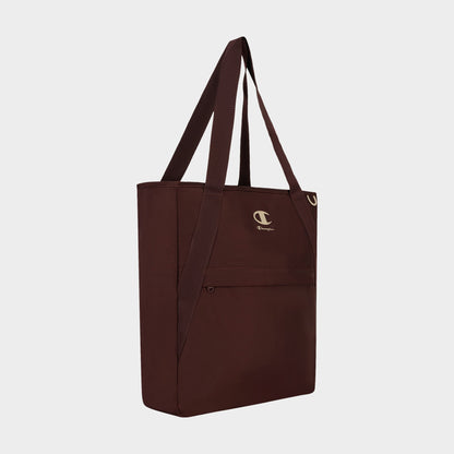 Introducing the Lottie Tote by Champion: a maroon nylon tote bag designed for durability, featuring long handles, a front zip pocket, and a small white Champion logo above the pocket. This versatile everyday accessory is showcased against a plain white background.