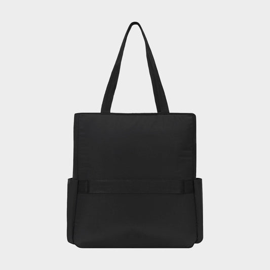 The Champion Explore Tote is a durable crinkle nylon tote bag in plain black, featuring two handles, two side pockets, and a simple rectangular silhouette, displayed against a light gray background.