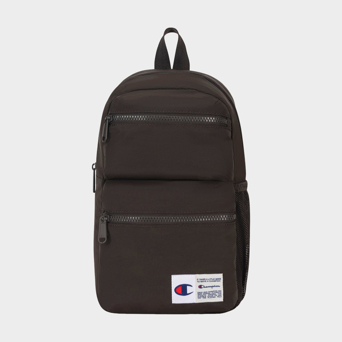 Introducing the Champion Explore Sling—a compact black sling bag featuring two front zippered pockets, a mesh side pocket, and a white Champion logo patch on the lower front. Designed for those who prefer to travel light, this sleek carry includes a top handle and black zippers, blending practical everyday utility with classic Champion style.