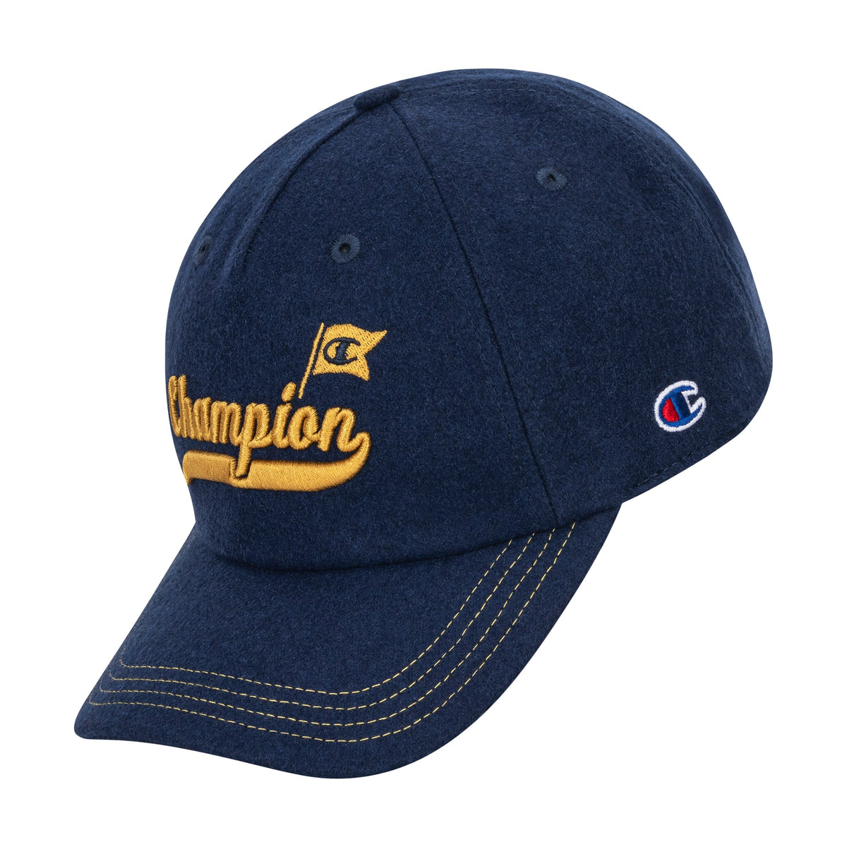 The Champion Sophomore Adjustable Cap is dark blue with yellow stitching and embroidery. "Champion" in yellow script and a small flag are on the front; the side has a classic collegiate blue, red, and white Champion logo patch.
