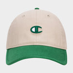 The Champion Briggs Washed Cotton Twill Adjustable Baseball Cap features a beige design with a green brim and a green and white embroidered C logo, crafted from washed cotton twill and shown on a plain white background.