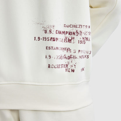 Off-white Champion Fleece Baseball Jacket featuring distressed, dark red text on the back with phrases including Rochester, New York and Established 1919.