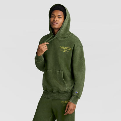 A person wearing an olive green Mineral Wash Pullover Hoodie, C Patch Logo and matching sweatpants.