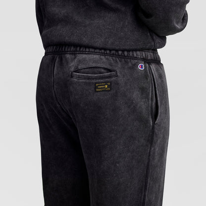 Black mineral wash Champion Mineral Wash Open Hem Pant featuring a back pocket, a small logo patch, and a small embroidered logo on the waistband.