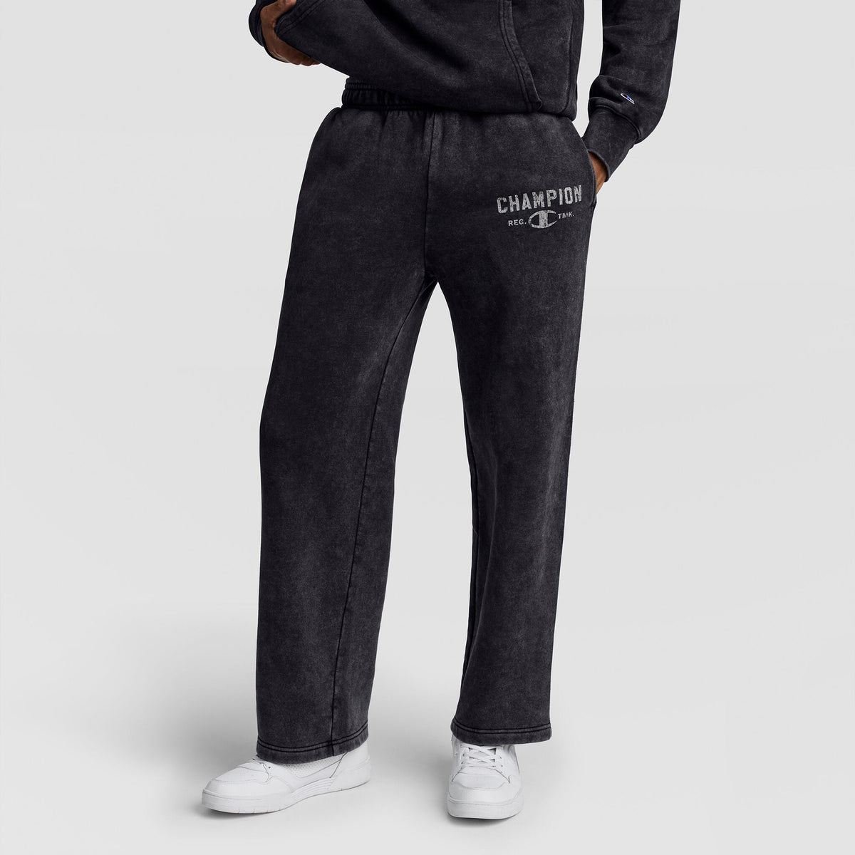 Black Mineral Wash Open Hem Pant with a straight-leg, open hem and a logo printed on the upper left thigh, featuring the vintage look of Champion men’s heavy open hem pants.