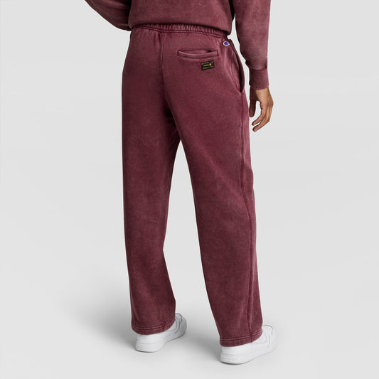 A person viewed from behind wearing maroon Mineral Wash Open Hem Pant sweatpants with an open hem and a back pocket.