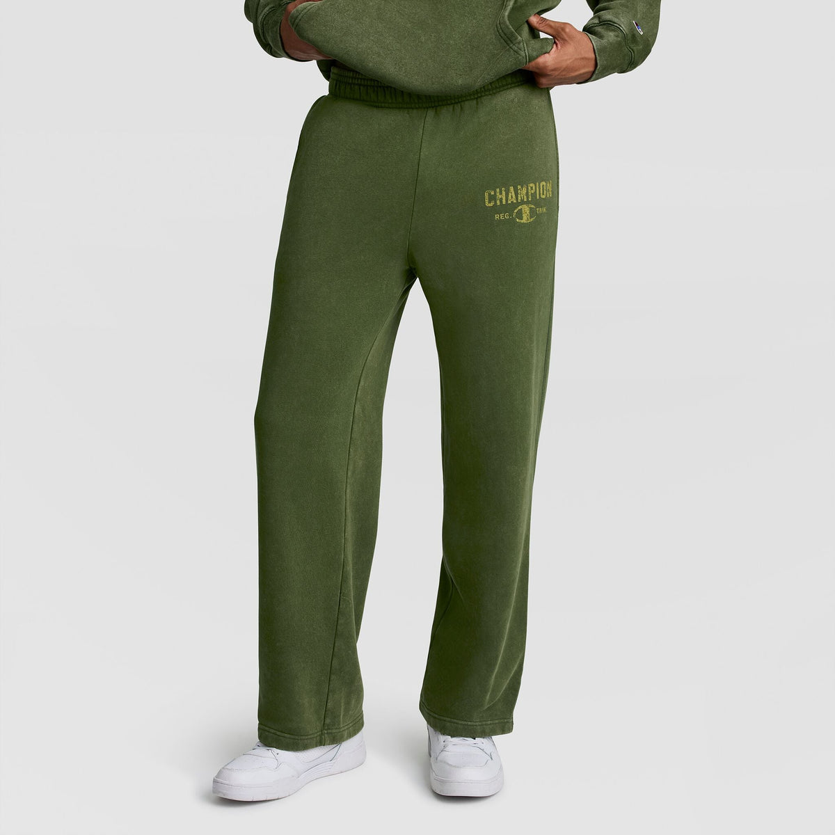 Olive green Champion Mineral Wash Open Hem Pant with a distressed graphic on the left hip.
