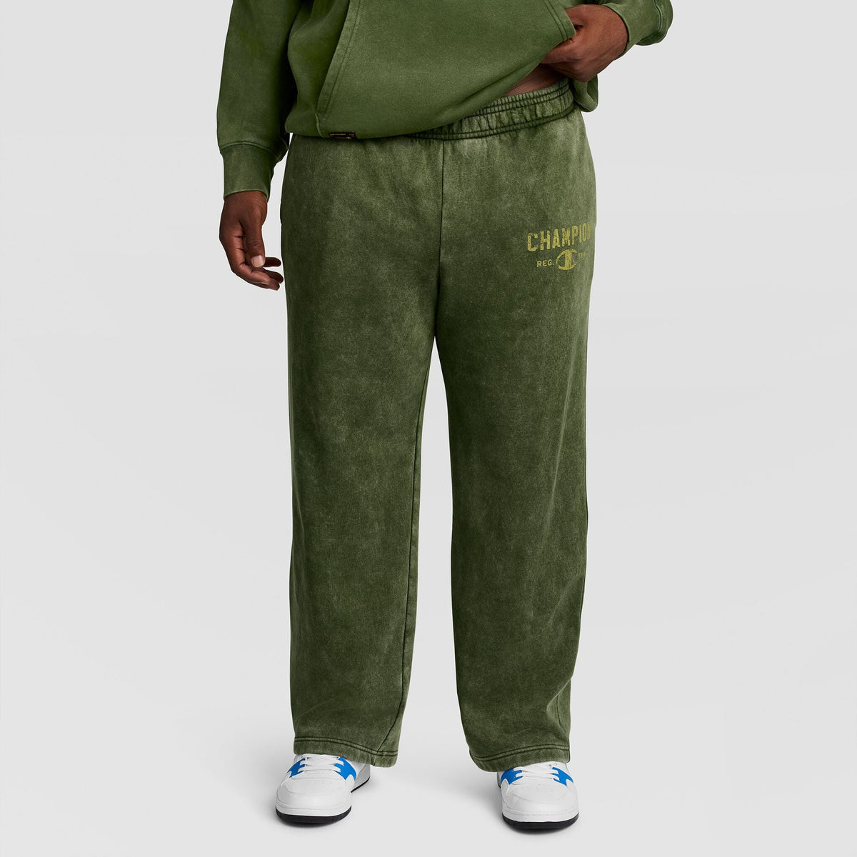 Olive green Mineral Wash Open Hem Pant by Champion with an open hem and a logo on the left thigh.