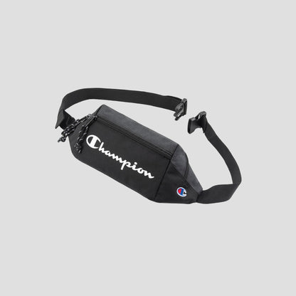 A black Champion Monitor Waist Pack with a zippered pocket and adjustable strap, featuring the white Champion logo on the front and a small Champion emblem on the side.