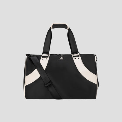 Black and white Oracle Duffel Bag by Champion with top handles and a detachable shoulder strap, displayed against a plain gray background. This versatile gym bag features a small Champion logo on the front.