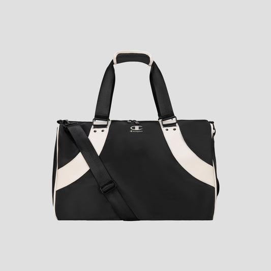 Black and white Oracle Duffel Bag by Champion with top handles and a detachable shoulder strap, displayed against a plain gray background. This versatile gym bag features a small Champion logo on the front.