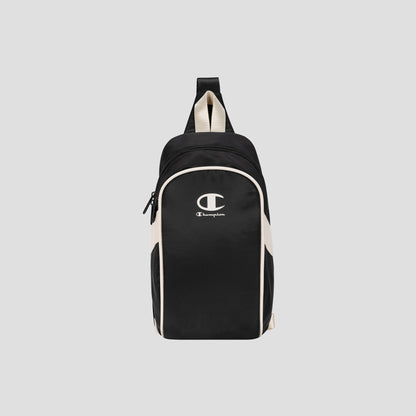 The Champion Oracle Sling Pack, shown in black and white against a plain light gray background, is perfect for use as a gym bag and features a front zipper pocket, white Champion logo on the front, and a top handle.