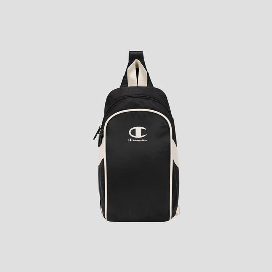 The Champion Oracle Sling Pack, shown in black and white against a plain light gray background, is perfect for use as a gym bag and features a front zipper pocket, white Champion logo on the front, and a top handle.