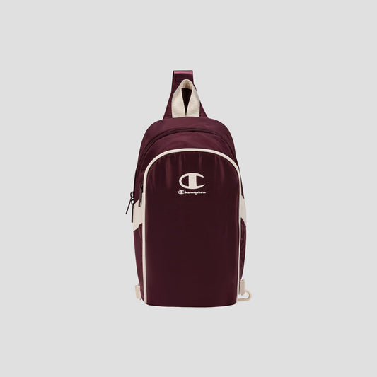 Oracle Sling Pack by Champion in maroon with white logo and accents, featuring a single shoulder strap and front zipper pocket, displayed on a plain light background—the perfect crossbody bag for the gym or everyday use.