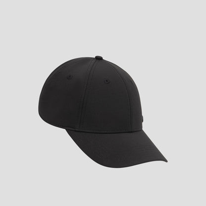 A Champion Ponytail Baseball Cap, crafted from performance stretch fabric in plain black, is displayed on a light gray background and angled slightly to the left.