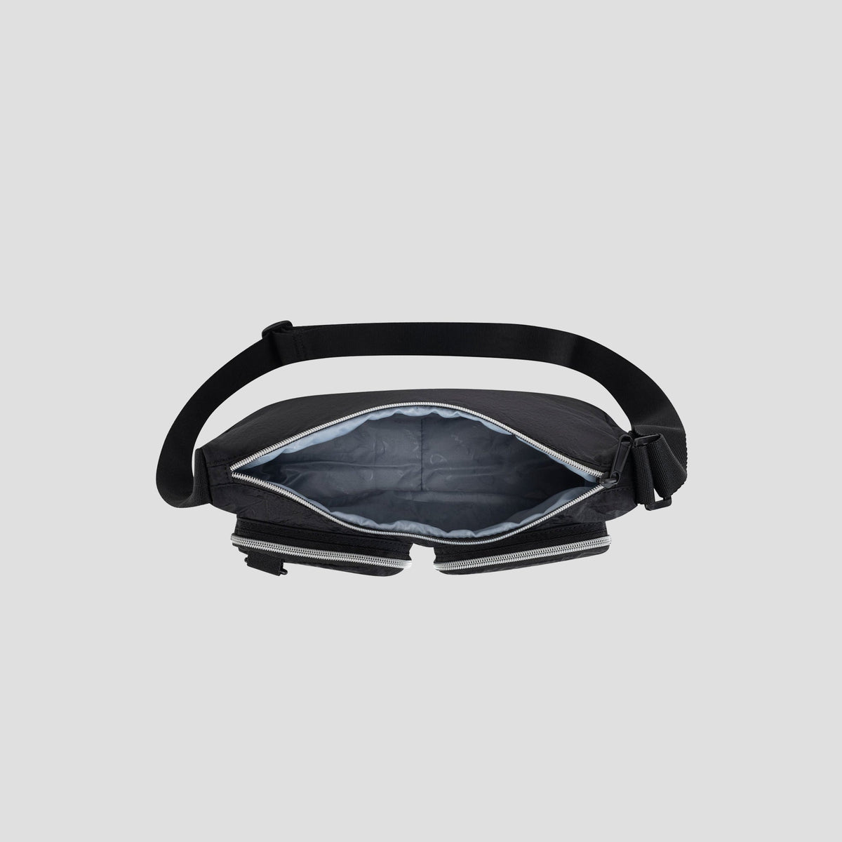 A top view of the Champion Quartz Small Messenger Bag, shown open with a padded gray interior and adjustable strap, displayed on a light gray background.