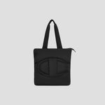 The Champion Quilted Billie Tote features black padded quilting with two handles and a large, rounded stitched design on the front, shown against a plain light gray background—a stylish everyday bag.