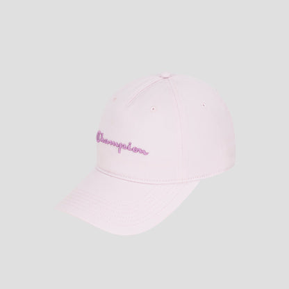 The Script Embroidery Adjustable Cap by Champion is crafted from premium cotton twill in a light pink hue, featuring the word “Champion” embroidered in purple cursive on the front. The cap is displayed against a plain light gray background.