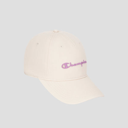 A Script Embroidery Adjustable Cap by Champion, in beige washed cotton twill, features a curved brim and the signature purple Champion logo embroidered on the front, shown against a plain gray background.