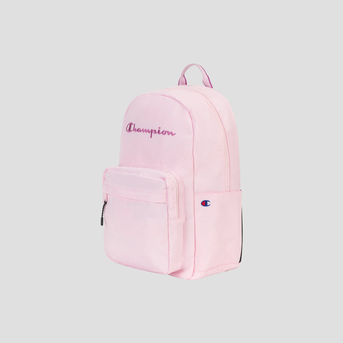 The Steady Backpack by Champion in light pink features a front zip pocket, side pocket, top handle, and a purple embroidered Champion logo on the front. Designed for practicality, it also includes a padded laptop sleeve for extra protection. The background is plain light gray.