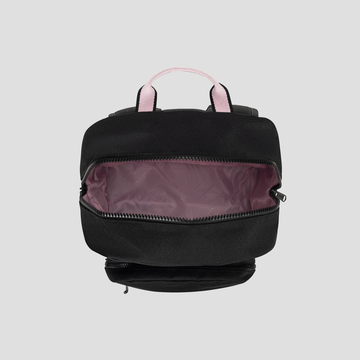 The Champion Steady Backpack is displayed from above in black with light pink handles. Its main zipper compartment is open to show a light mauve-pink interior lining and a padded laptop sleeve for organizing daily essentials. The background is plain light gray.