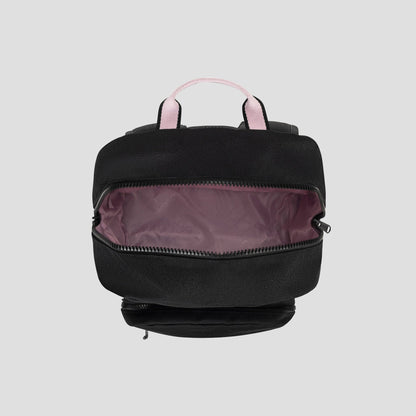 The Champion Steady Backpack is displayed from above in black with light pink handles. Its main zipper compartment is open to show a light mauve-pink interior lining and a padded laptop sleeve for organizing daily essentials. The background is plain light gray.
