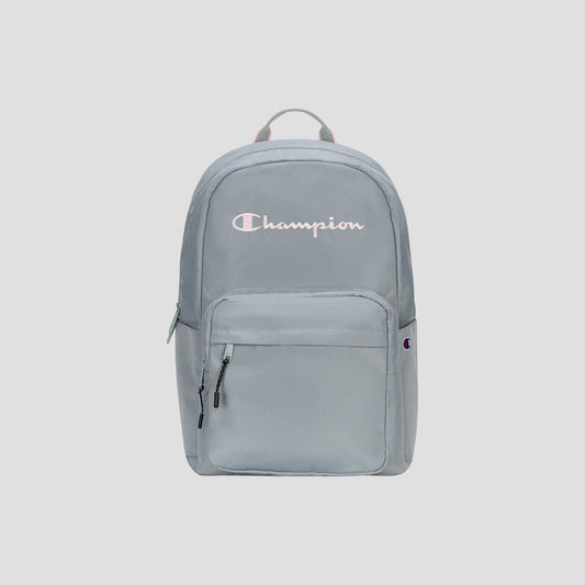 Introducing the Steady Backpack from Champion: this light gray bag features a front zip pocket, dual zipper pulls, and the Champion logo in white and pink displayed across the upper front. Designed with a fabric top handle and a streamlined, minimalist look, it’s perfect for carrying all your essentials in style.