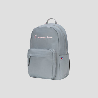 The Steady Backpack by Champion is shown upright against a plain, light background. This light gray backpack features a front zip pocket, a top handle, and the embroidered Champion logo on the front.