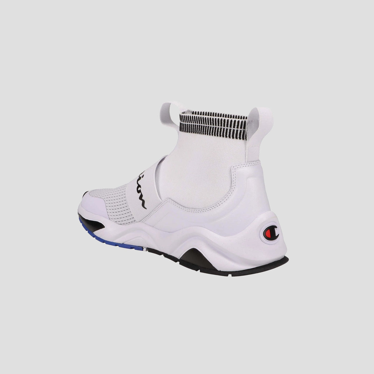 The Champion Kids' Rally Pro features a white knit slip-on design with a high sock-like collar, black and blue sole accents, and the Champion logo on the heel—shown from the back against a plain light background.