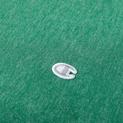 A close-up of a small, white and gray embroidered Champion C logo on green fabric—reminiscent of the signature detailing found on Champion’s Reversible Solid Jersey Comforter Sets.