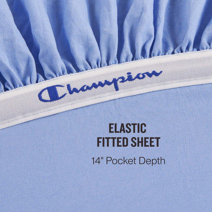 Close-up of the Champion Elastic Logo Microfiber Sheet Set in light blue, featuring an elastic band with embroidered Champion logo detail. Text reads: ELASTIC FITTED SHEET 14″ Pocket Depth.