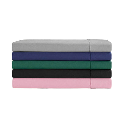 A neatly arranged stack of five Champion Peak Comfort Microfiber Sheet Sets in gray, navy blue, green, black, and pink is displayed on a white background—each set features deep pocket sheets for a snug fit, designed as athletic bedding to provide ultimate comfort.