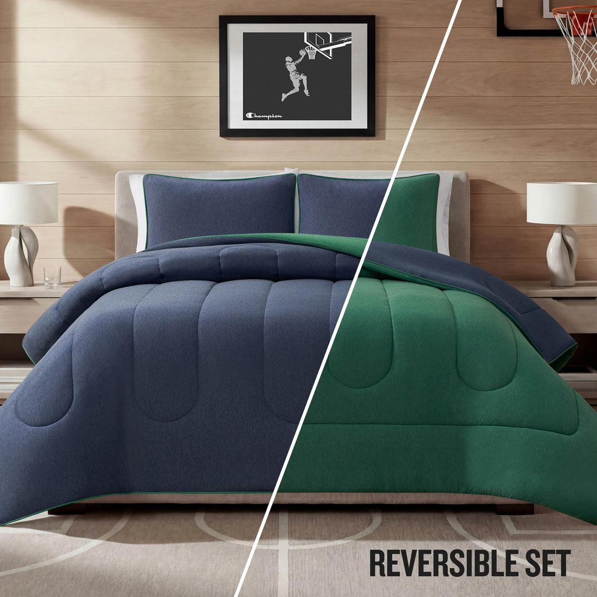 A neatly made bed features the Champion Premium Reversible Solid Jersey Comforter Set in blue and green, matching pillows, two bedside tables with lamps, and a framed basketball artwork above the headboard. The text “REVERSIBLE SET” appears at the bottom right.