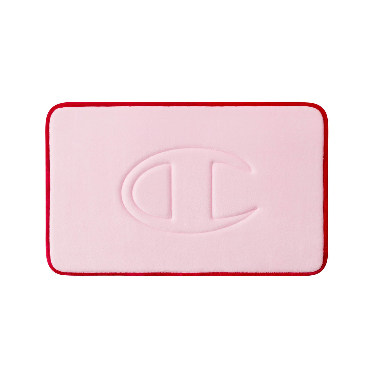 A rectangular pink Champion Quilted Logo Memory Foam Bath Mat with rounded corners and a red border, featuring an embossed large C-shaped logo in the center.