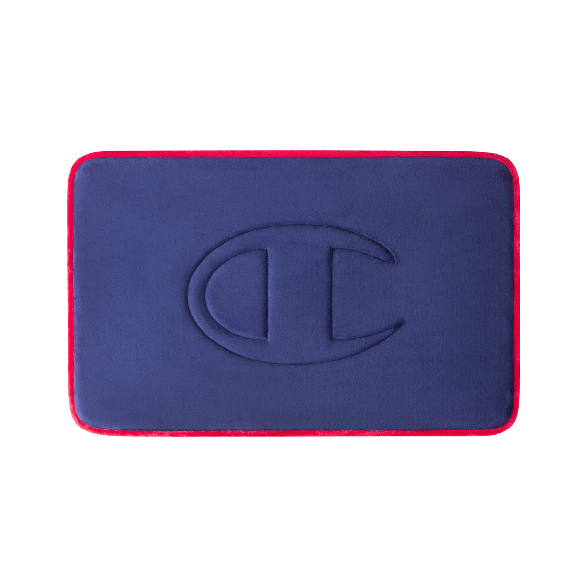 A rectangular navy blue Quilted Logo Memory Foam Bath Mat by Champion, featuring rounded corners, red edges, and an embossed large C logo in the center, displayed against a white background.