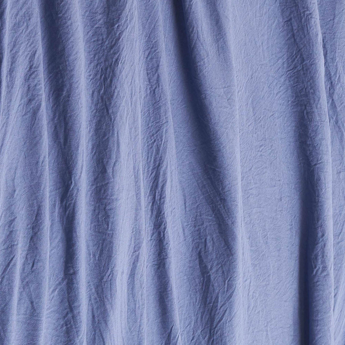Blue wrinkled fabric with visible vertical creases and folds, creating a textured appearance reminiscent of the Champion Embroidery Patch Microfiber Sheet Set.