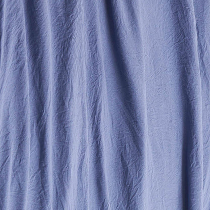 Blue wrinkled fabric with visible vertical creases and folds, creating a textured appearance reminiscent of the Champion Embroidery Patch Microfiber Sheet Set.