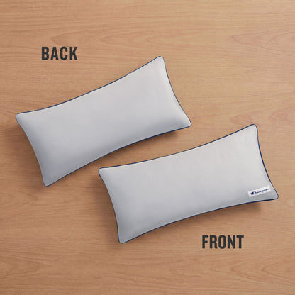 Two Champion Faux Wool Body Pillows rest on a wooden surface, labeled BACK and FRONT. The front pillow showcases a small Champion logo tag in the corner and is filled with plush polyester for superior comfort, while the back pillow remains plain.