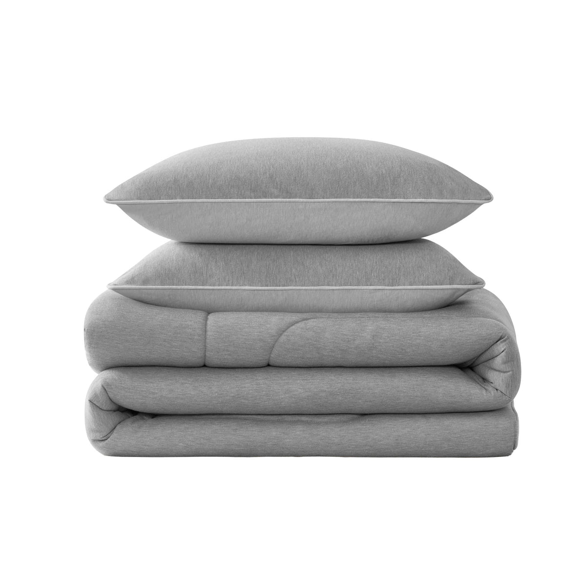Two gray pillows are stacked on top of a neatly folded Champion Premium Reversible Solid Jersey Comforter Set, all set against a plain white background.