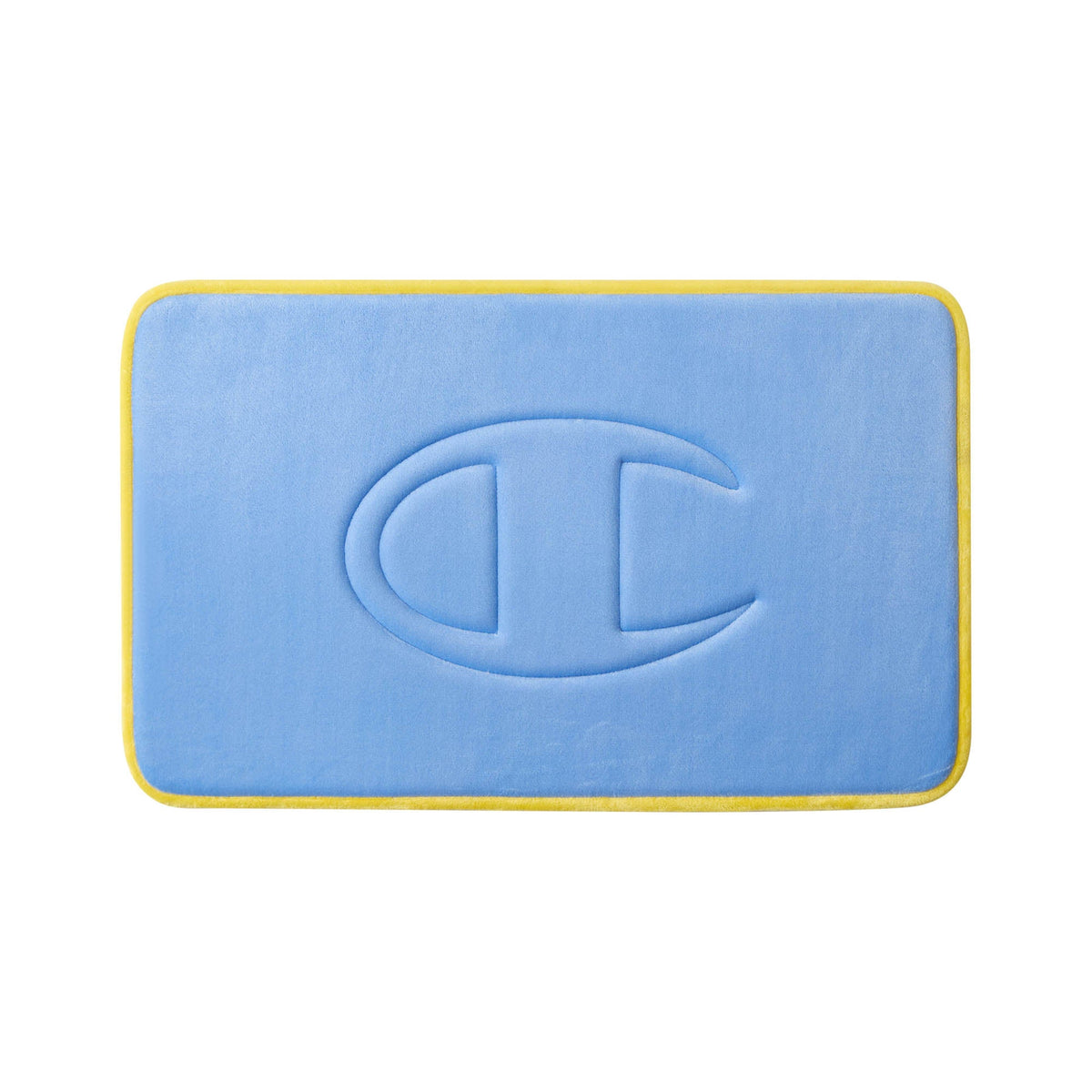 A rectangular blue Quilted Logo Memory Foam Bath Mat by Champion features rounded corners, yellow trim, and an embossed large C shape design in the center. This stylish bath mat is photographed on a white background.