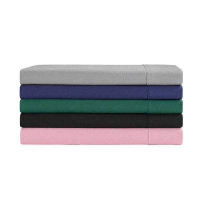 A stack of five folded Champion Peak Comfort Microfiber Sheet Sets in gray, navy blue, green, black, and pink is arranged from top to bottom against a white background. These athletic bedding essentials feature deep pocket sheets for a perfect fit and comfortable sleep.