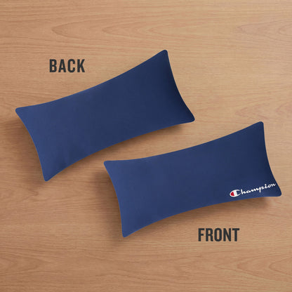 Two navy blue rectangular Jersey Body Pillows by Champion rest on a wooden surface. The FRONT pillow showcases the iconic Champion logo for an athletic accent, while the BACK pillow is plain with no logo. Crafted from soft jersey knit fabric, these Champion pillows bring sporty style and comfort to any space.