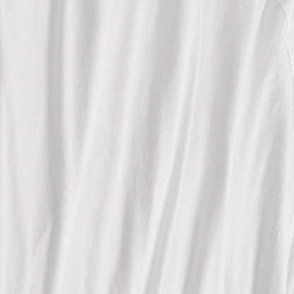 A close-up of a white fabric with soft, vertical folds and subtle wrinkles reveals a slightly textured appearance—beautifully illustrating the smooth feel of the Champion Embroidery Patch Microfiber Sheet Set for athletic-inspired bedding.