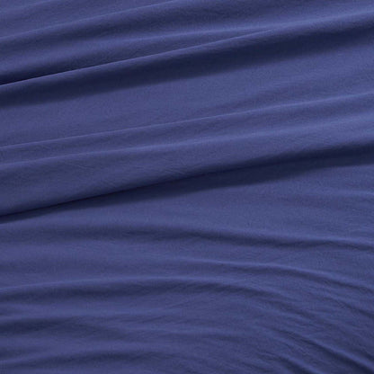 A close-up of the Champion Elastic Logo Microfiber Sheet Set in blue, featuring gentle diagonal folds and a soft texture that exudes smoothness and comfort—beautifully conveying the inviting appeal of this microfiber bedding.