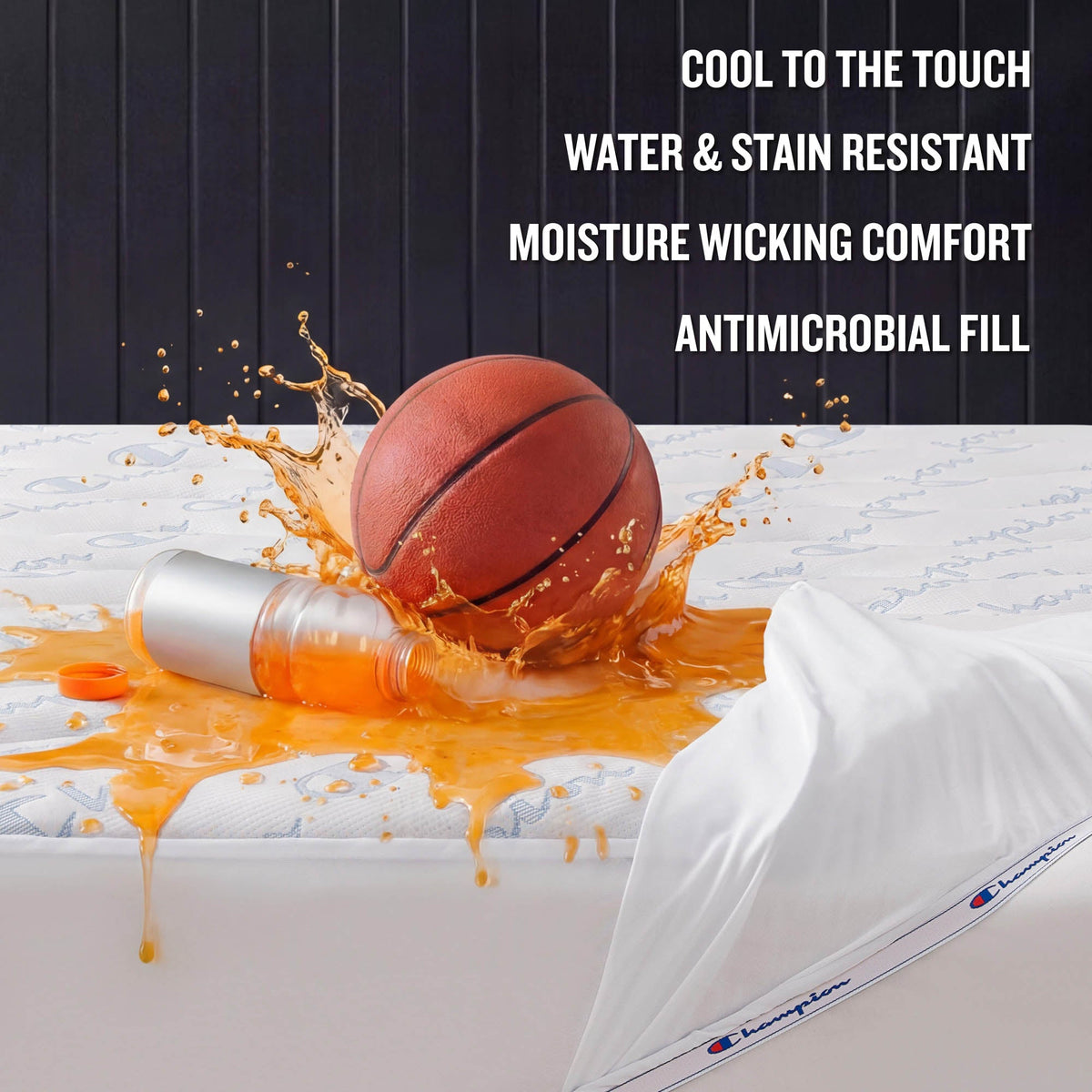 A basketball sits next to a spilled orange drink on a mattress topped with a pillow, showcasing the Champion Cooling Knit Mattress Pad—crafted for cool-to-the-touch comfort with premium cooling technology, featuring a stain-resistant and water-repellent surface, moisture-wicking design, and advanced antimicrobial fill.